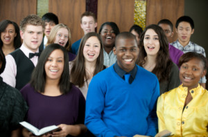 A diverse group of young adults singing in church.